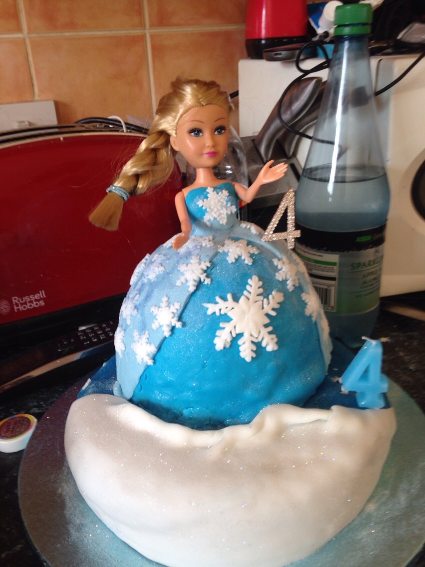 On a base ices to set scene and edible glitter for snowy effect