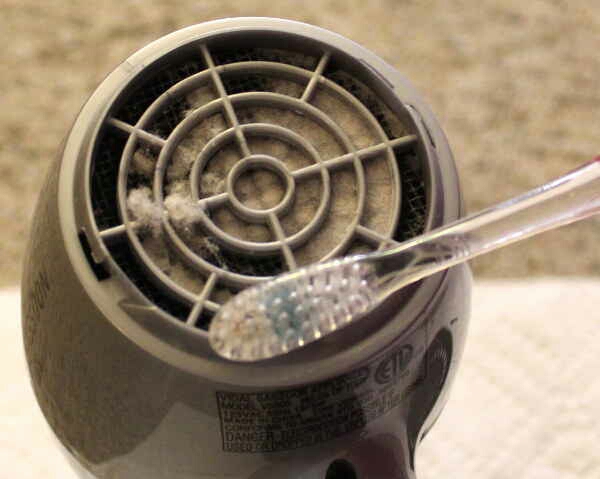 14. Use an old toothbrush to get rid of the dust in the back of your blow dryer.
Just make sure you pop off the grill first.