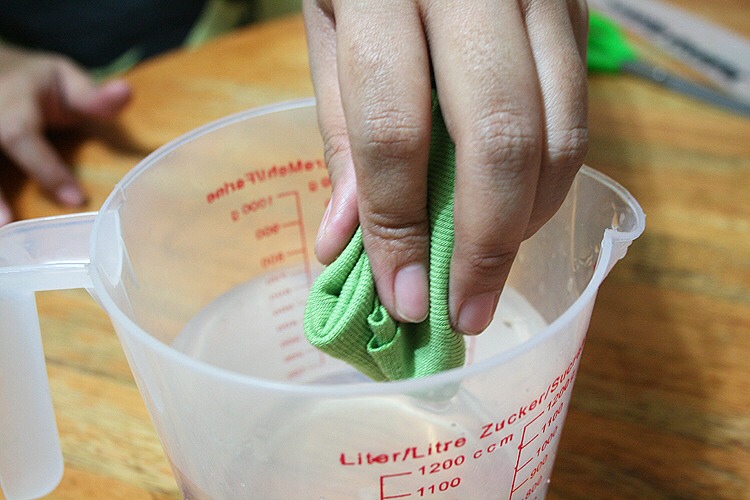 Step 3: Wet a piece of cloth with warm water.