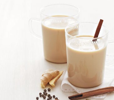 Place the cardamom, cloves, and peppercorns in a resealable plastic bag and crush with a heavy skillet.
Place the crushed spices in a medium saucepan, along with the cinnamon sticks, ginger, milk, and 2 cups water; bring to a boil. Remove from heat, add the tea bags, cover, and let steep for 10 min