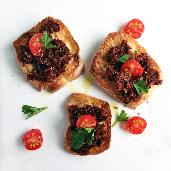 Sun-Dried Tomato Crostini

To serve your sun-dried tomato pesto crostini, spread the pesto on toasted baguette slices and garnish with cherry tomato halves, parsley sprigs, and a drizzle of olive oil.