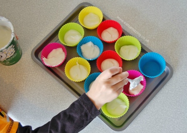 STEP 2
Using a spoon, dollop some yogurt into the bottom of each cake case until all the yogurt has gone.
