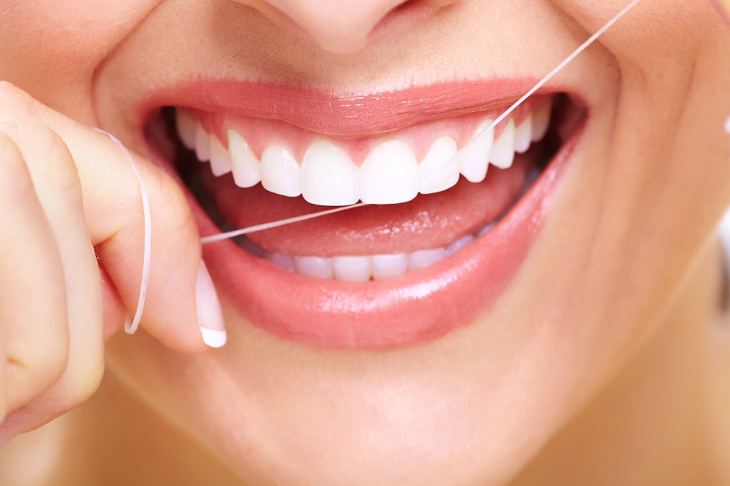 Floss your teeth. Floss in a C shape around each tooth