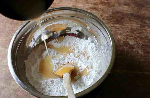 On the stovetop, combine the butter, corn syrup and sugar and boil for about 3-4 minutes. It’s best to use a candy thermometer, cook until it reaches 230 degrees or the soft ball stage. Remove from heat and stir in the vanilla.
Carefully pour the mixture into the powdered sugar mixture.
