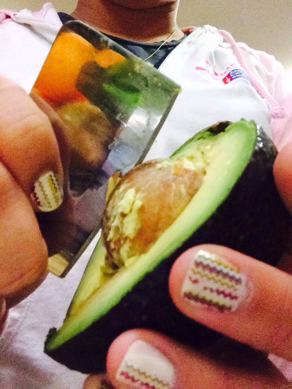 First cut the avocado in half and take the seed out!
If you have trouble trying to take the seed out use a knife. Once the knife is partially cut into the seed (be gentle) twist and pull out...