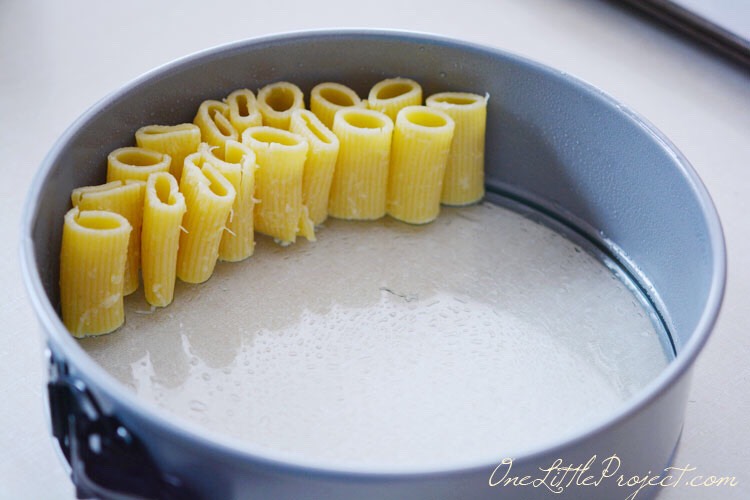 Take the cooked rigatoni and stand each piece up on its end in the pan. Continue until the whole pan is tightly packed.