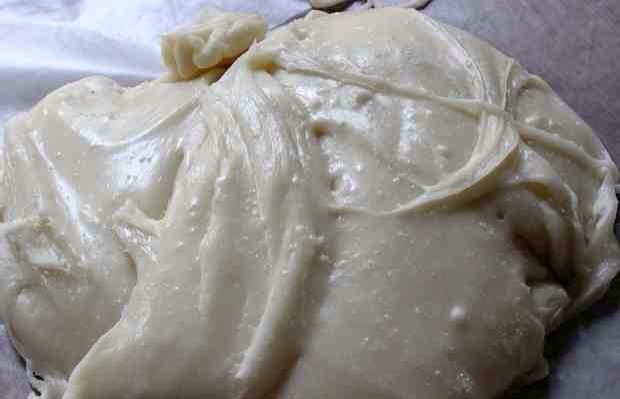 Turn the mixture out onto a piece of wax paper and let cool until you can easily handle it, about 10-15 minutes.
