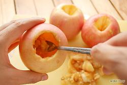 Using a small spoon, carefully scrape out the insides of the apple until an apple cup is formed. Save the pulp in a small bowl for the filling.
Rub a tiny bit of lemon juice on the insides of each apple to prevent them from turning brown.