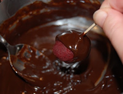Dip the red velvet cake balls into the chocolate! 