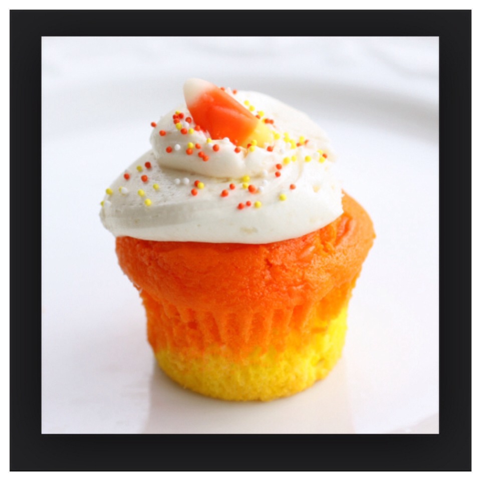 This cupcake is perfect for Halloween! Mix a white cupcake batter and separate it into two separate bowls. Dye one bowl yellow and the other bowl orange. In the cupcake tin pour in the yellow batter then the orange on top then frost with white icing and place a candy corn on top