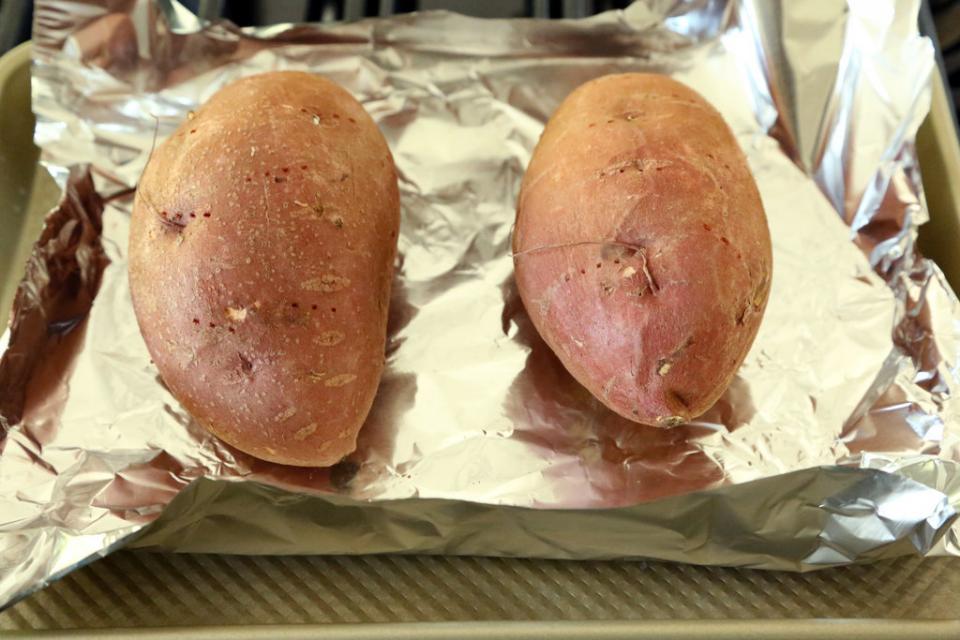 14. Sweet Potatoes
Sweet potatoes are high in fiber to keep you full and regulate blood sugar — which can help you kick cravings and lose pounds. But instead of the deep-fried sweet potato fries, opt for something healthier, like this sweet potato black bean burrito.
