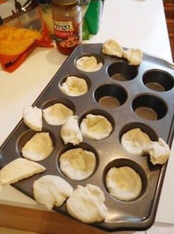 Lightly line a cupcake tin with olive oil. You can use butter but I found olive oil works better. Take small portions of the dough and kneed it big enough to line the inside of the tin. The dough will expand as it cooks so it doesn't need to be thick at all. Make sure you line the edges well.