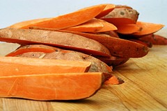Cut potatoes lengthwise into 1-inch wedges. Toss wedges with oil and spices in a large roasting pan and roast in middle of oven 20 minutes. Turn wedges over with a spatula and roast until tender and slightly golden, 15 to 20 minutes more.