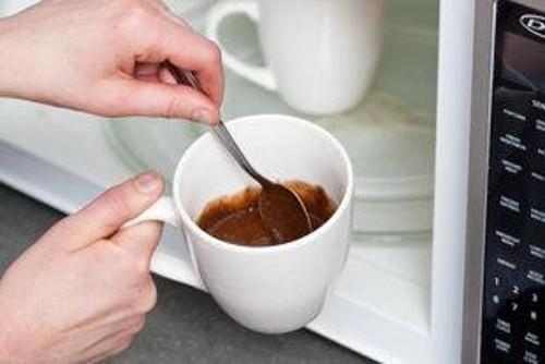 In separate bowl, combine flour and baking powder. Whisk flour mixture into chocolate mixture until combined. Divide batter evenly between 2 (11-ounce) coffee mugs.