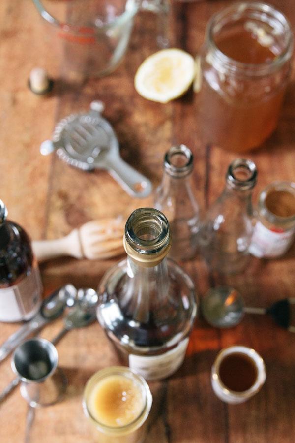 In a large glass jar mix 16 ounces of cider with 6 ounces of calvados. Juice one full lemon into the mix. Add 2 tablespoons of honey and stir well to make sure the honey incorporates into the mixture (this may take a few minutes). Add 3 tablespoons of vanilla syrup then 1/4 teaspoon of cinnamon. Sti