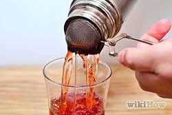 Strain the ingredients into a 14 oz. hurricane glass filled with ice.
