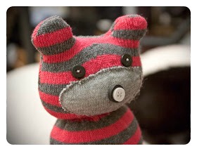9. Now for the fun part! Attach your 2 little eyes, and nose. I used 2 buttons to create his nose – a black button, with a slightly smaller white button on top. This is my favourite part in creature creating! They really start to come alive when you add the eyes :)