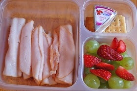 turkey, crackers, Laughing Cow Light cheese, strawberries and grapes
