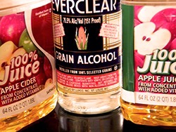1 gallon apple cider
1 gallon apple juice
6 (3 inch) cinnamon sticks
1 1/2 cups white sugar, or to taste
1 (1 liter) bottle 190 proof grain alcohol (such as Everclear™)