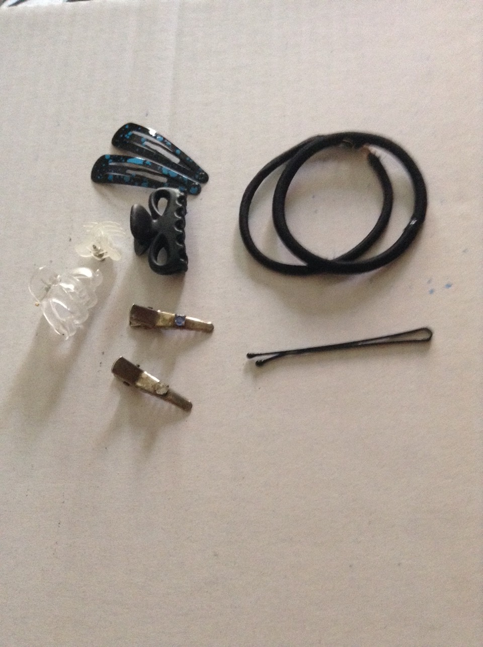 The fifth thing I have is hair stuff. For example: hair elastics, bobby pins, hair clips, and barrettes. These would be handy if you need to put your hair up or you have annoying fly-always.