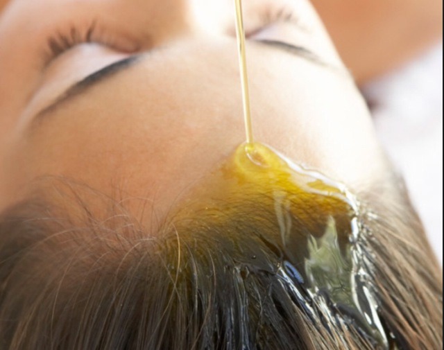 Rub the oil all over your scalp, try not to miss any to get the best results.