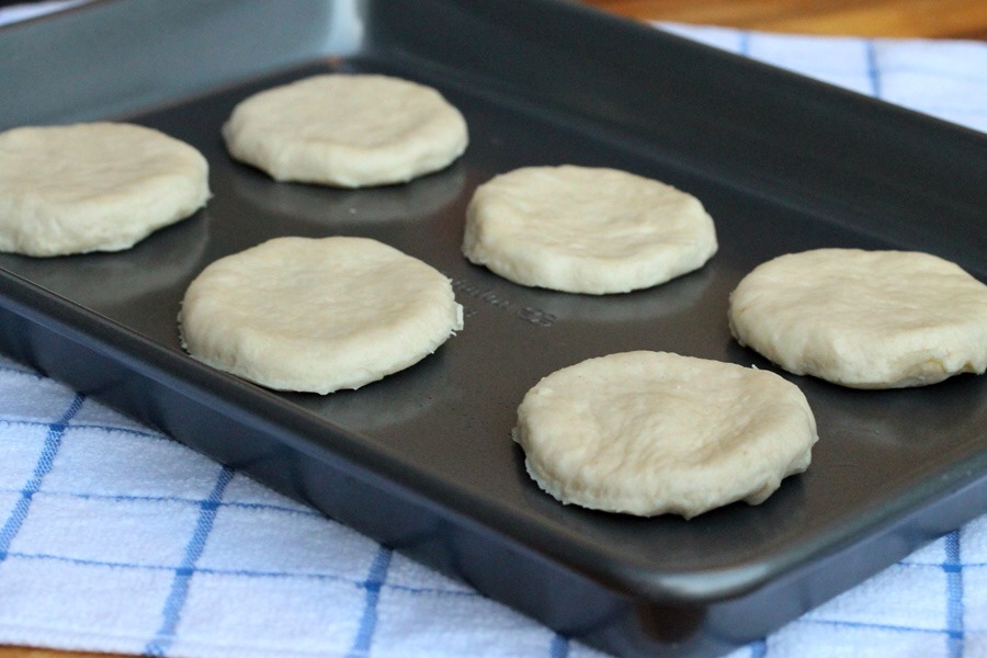 Transfer the biscuits on a baking sheet. Bake on the top rack for 10-15 minutes or until golden brown. After 6 minutes rotate the pan. Make sure the bottoms aren't getting too crisp. If so put an extra baking sheet under it. When they are finished, brush some butter overtop! Yum!