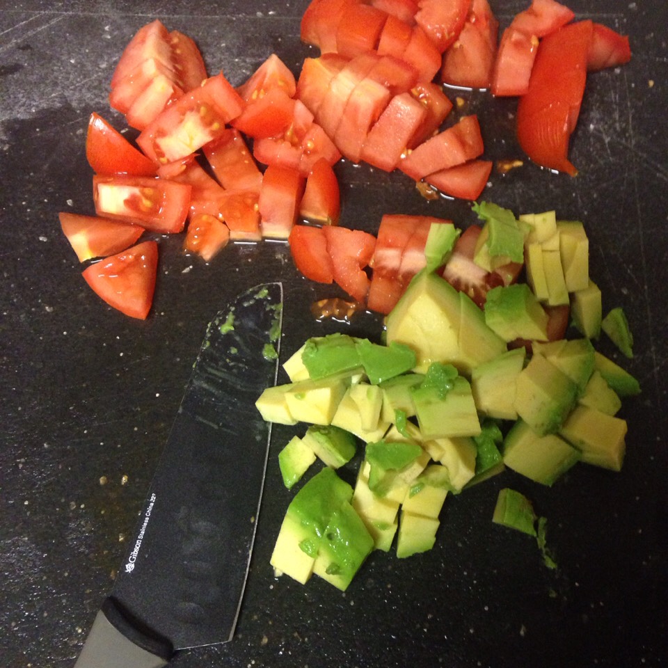 Cut fresh tomatoes and avocado.