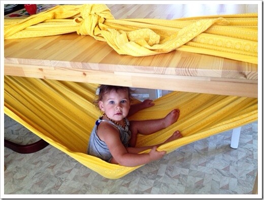 9. Need a place to put your kid?Make a hammock with a blanket tied around a table.