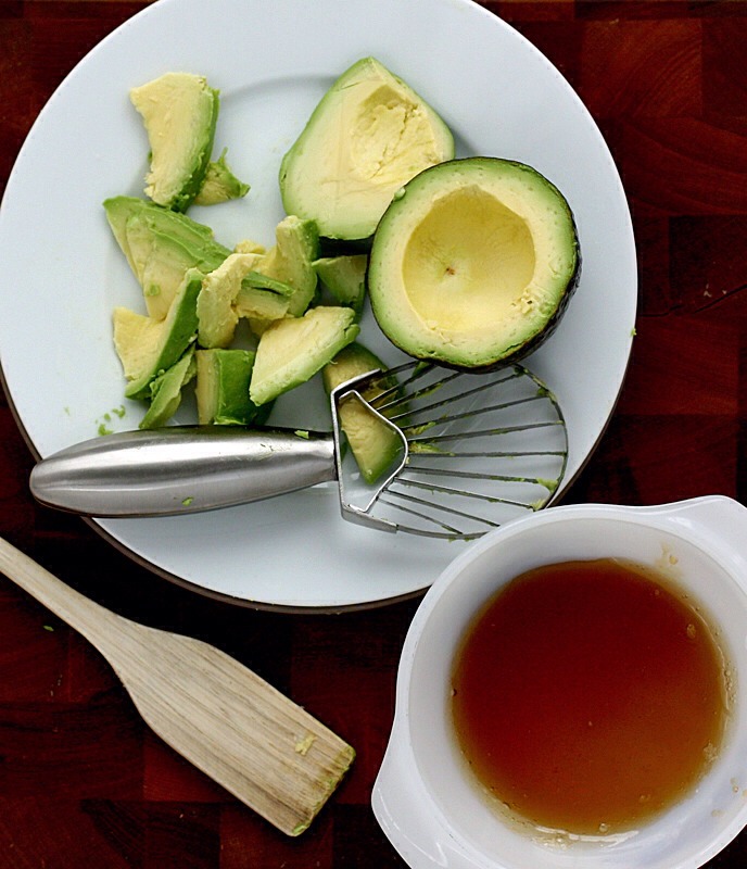 Next, let’s talk ingredients.  It wouldn’t be DIY without some stuff from the kitchen, so pop into your cupboards and grab an avocado and some honey.

Cut the avocado in half and slice up the pieces.