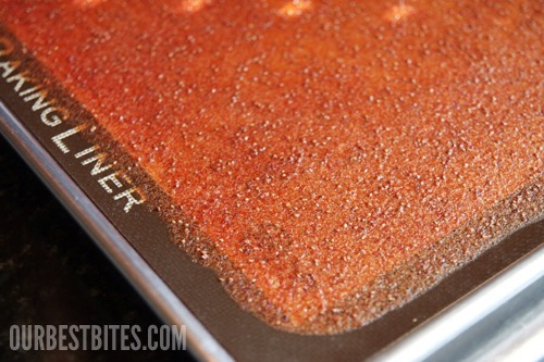 I never thought fruit roll-ups could be gorgeous, but this raspberry one is gor-ge-ous!  You can certainly strain out the seeds before cooking, but I happen to think straining raspberry seeds is a huge pain in the rear and I love the little bit of texture it gives to the final product.


