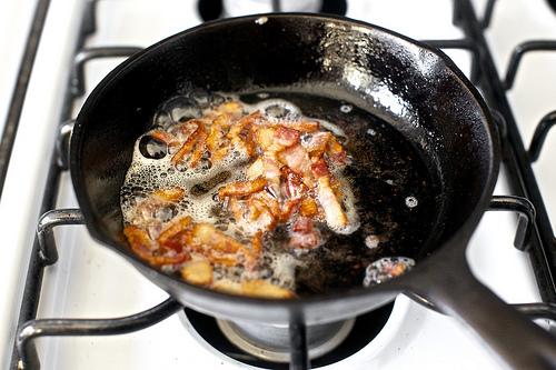 Split your rolls and put them in to toast.

Place frisée in a medium bowl. Cut bacon crosswise into 1/4-inch wide lardons. In a small heavy skillet, cook bacon over moderate heat, until pieces are crisp. With a slotted spoon, transfer bacon to paper towels, reserving bacon fat in pan.