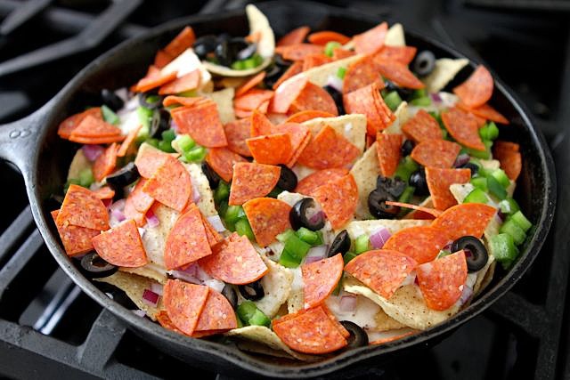 Top with the onions, pepperoni, olives, and bell pepper.