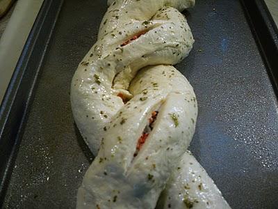 Separate egg.  Beat egg white and oregano and mix; lightly brush over dough.  Using a serrated bread knife, cut a 3-inch slit in each of the top sections of the twist to reveal filling.