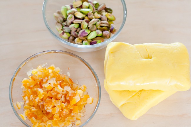 Ingredients;

•17 ½ oz. (500g) Marzipan
•2 oz. (60g) Pistachios, shelled & peeled, whole or roughly chopped
•3 oz. (90g) Candied Orange Peel, finely cut
•2 Tablespoons (1 oz. / 30ml) Cointreau or Grand Marnier Liqueur, optional
•10 ½ oz. (300g) White Chocolate, finely chopped for tempering.