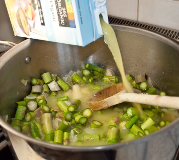 Add the chopped asparagus to the pot, along with the chicken broth, salt and pepper. Bring to a boil, then cover and simmer for about 30 minutes until the vegetables are very tender.