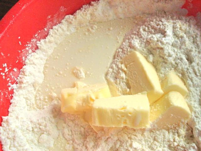 Add 1/2 stick (1/4 cup butter) and 1/4 cup milk. Don’t mix.

I cut up my stick of butter because I decided I could afford the extra 10 seconds of effort. If you can’t, no sweat. Cut another corner. Enjoy.