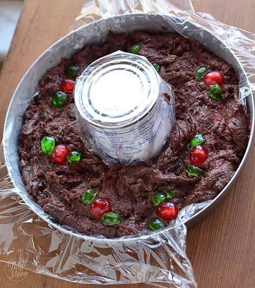 Spoon fudge into pan around can, making sure to center the can if it drifts.  The fudge will start to set, so quickly garnish with “holly” made from cut candies (have them cut ahead of time).  I sometimes sprinkle red or green sugar over the fudge as well.