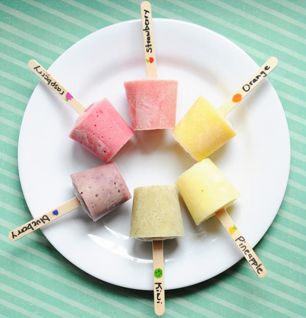 12. Fresh fruit frozen yogurt pops:
Blend 1.5 cups of vanilla yogurt, two cups of strawberries, and one tbsp of honey.
Repeat with different fruits to make multiple flavors of popsicle mixture.
Then, pour the mixture into popsicle molds, label each stick with the corresponding flavor, and freeze.

