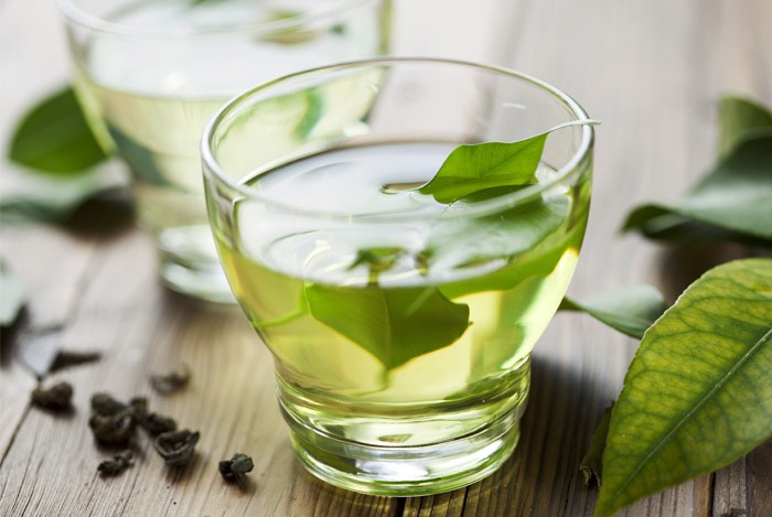 Place peeled ginger slice into the bottom of a mug along with a tea bag.  Pour hot (boiled) water over and allow to steep for about 3 minutes.  Add mint now if desired.