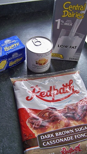 Combine brown sugar and milk in sauce pan and stir until the sugar begins to dissolve. Cook over medium – high heat until mixture reaches the softball stage, about 235°. Remove from heat and add butter and vanilla. Mix until smooth and creamy. Pour into a buttered 9 x 9 glass pan and let set.