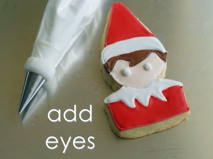 With a #2 tip, pipe eyes on the faces in white. {We call these "zombie elves."}