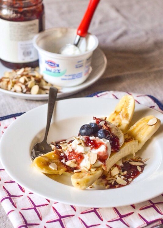 Breakfast banana split with yogurt and jam