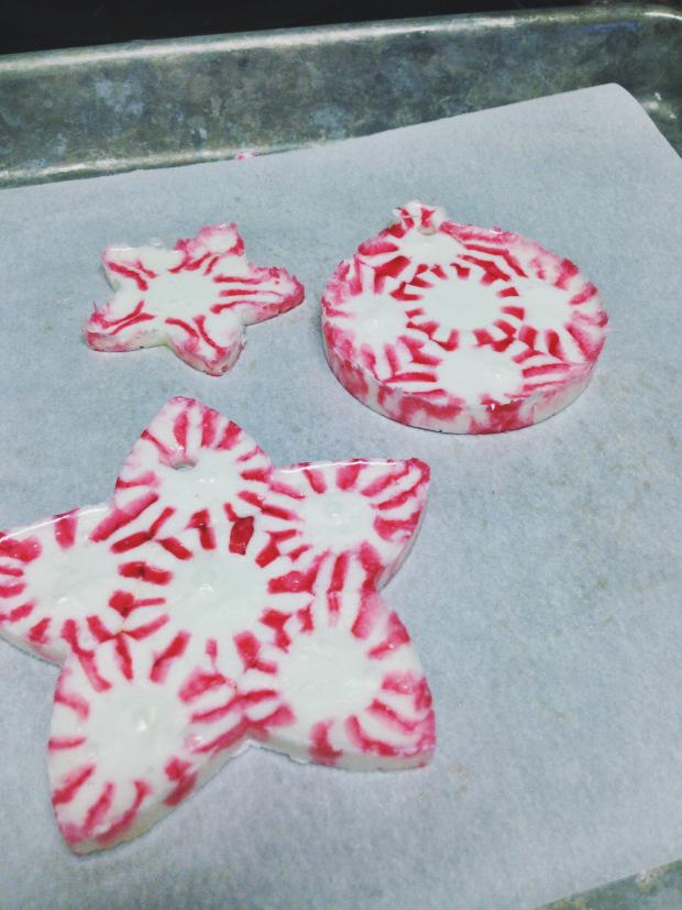 Lightly coat a toothpick with cooking spray and use it to make a hole in each group of candies. Let candy sit inside cookie cutter until it re-hardens. Once hard, carefully stretch out the cookie cutter, pulling it away from the candy, to pop out your ornament.