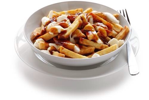 7. Poutine
While delicious, poutine is one of the most unhealthy foods you could eat. Fried potatoes are topped with artery clogging cheese curds and coated in thick fatty gravy. This Canadian favorite is packed with fat.