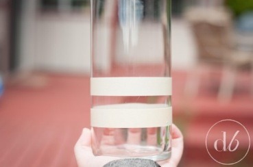Carefully tape even lines around your glass. Vary the height of the lines for visual interest. You don’t have to do lines if you don’t want to – feel free to mix it up by putting polka dots, triangles, zig-zags, you name it! Just keep in mind that whatever the tape is covering will be clear glass.