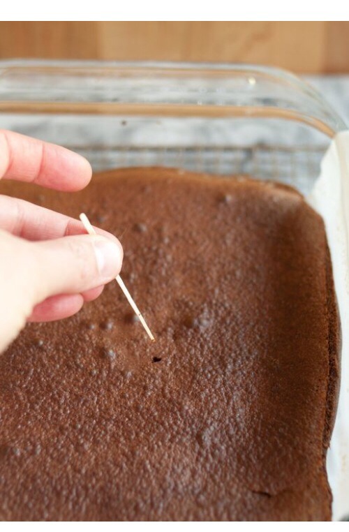 11. Look to see if the brownies have pulled away from the sides of the baking pan and test the brownies by inserting a toothpick, if nothing sticks to the toothpick then they are done