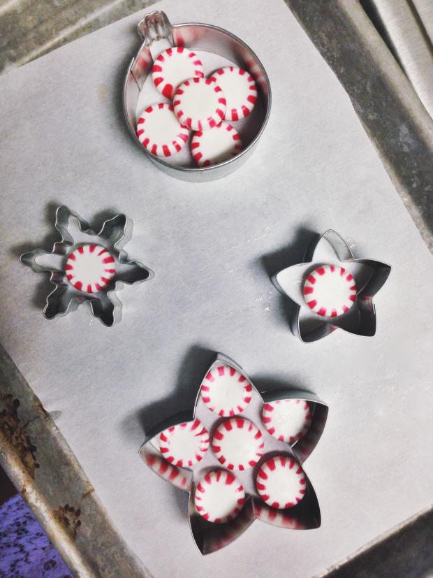 Preheat oven to 350F. Line a baking sheet with parchment paper. Spray the inside of each cookie cutter with cooking spray. Lay cookie cutters on baking sheet and fill with a layer of peppermints.