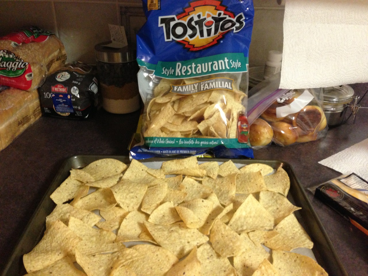 Put parchment paper on a pan and place tostitos evenly on pan