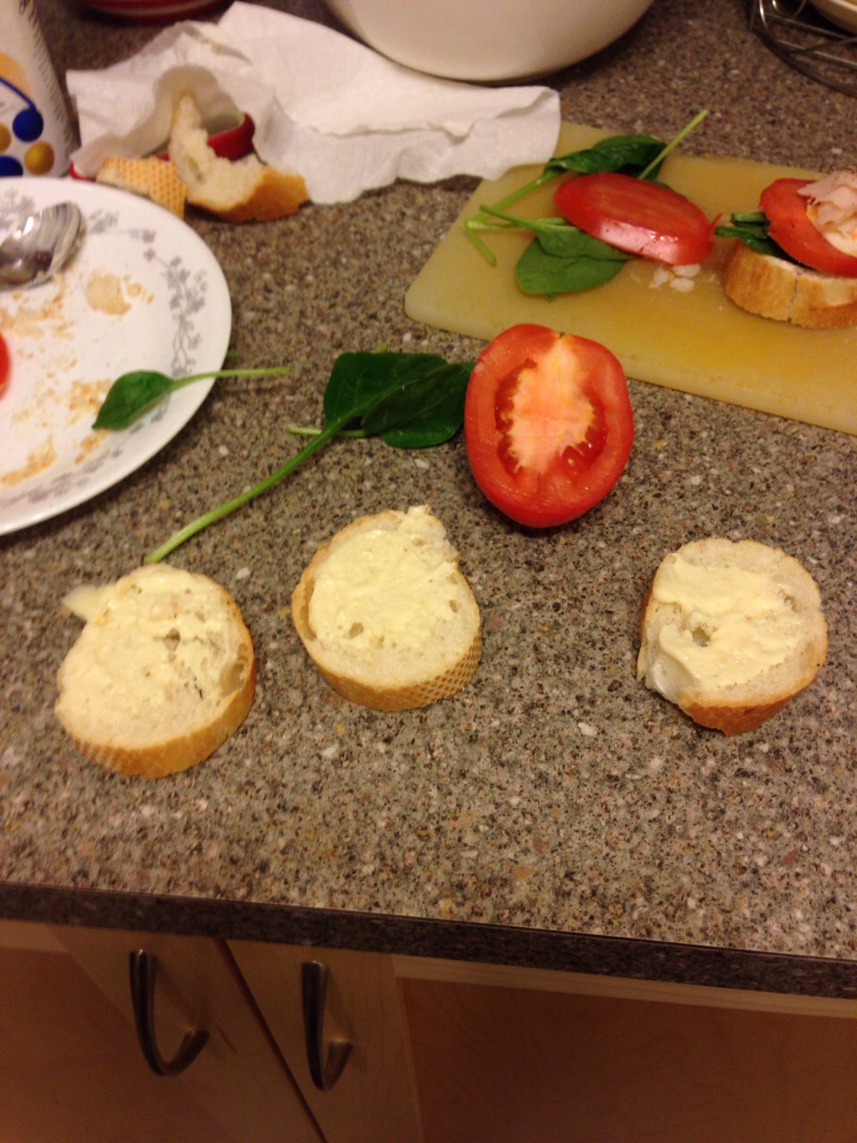 Slice your tomato, baguette and spinach.
Apply some the mayonnaise.