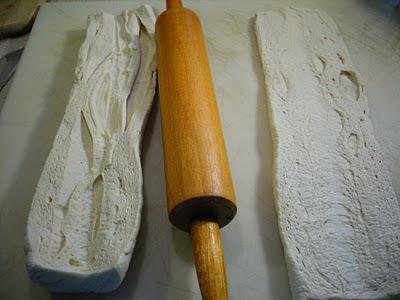 Spread open flat and lightly sprinkle additional flour evenly over dough.  roll dough gently to a 4-inch width, creating a well down center of each loaf.